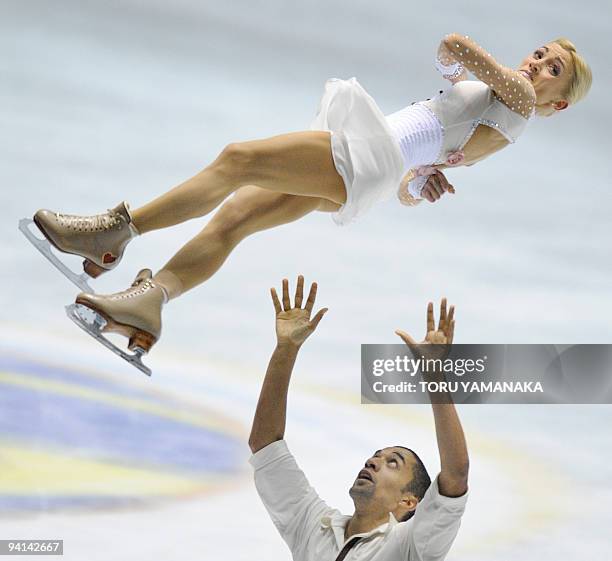 German Robin Szolkowy tosses his partner Aliona Savchenko during their free skating program in the pairs' competition at the figure skating ISU Grand...