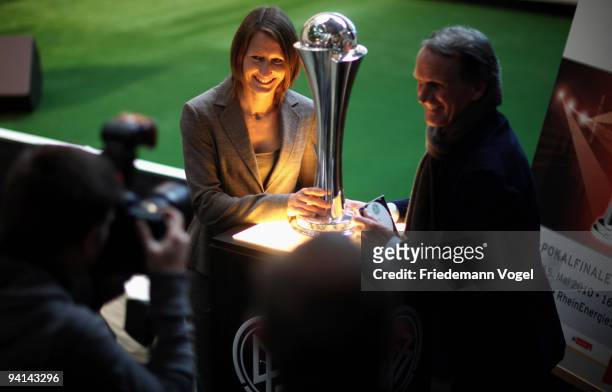Sonja Fuss and president of FC Koeln Wolfgang Overath pose with the trophy during the German Football Association women trophy presentation at the...