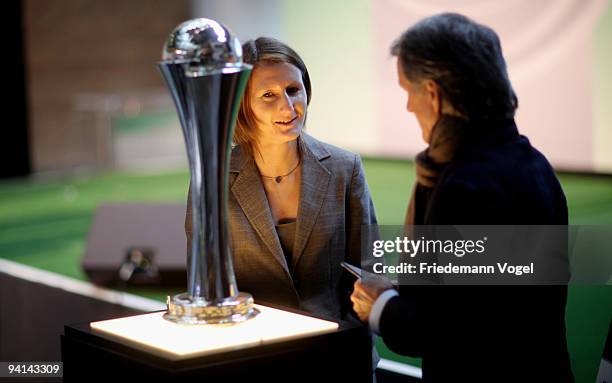 Sonja Fuss and president of FC Koeln Wolfgang Overath pose with the trophy during the German Football Association women trophy presentation at the...