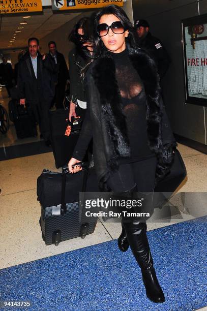 Television personality Kim Kardashian leaves the John F. Kennedy International Airport on December 08, 2009 in New York City.