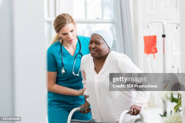 hospital nurse assists senior patient - iv drip at home stock pictures, royalty-free photos & images