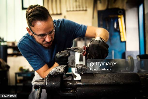 manual worker in metal workshop - plier stock pictures, royalty-free photos & images