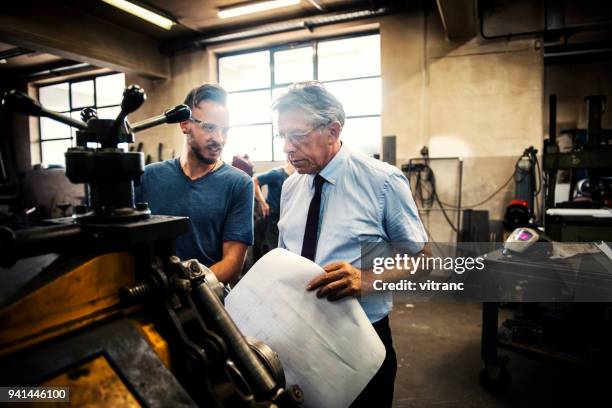 checking blueprints - mechanical engineering blueprints stock pictures, royalty-free photos & images