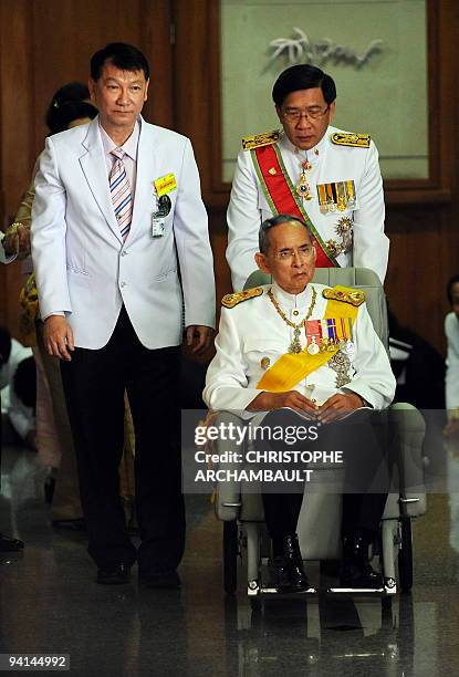 Thai King Bhumibol Adulyadej leaves the Siriraj Hospital on a wheelchair pushed by doctors, in Bangkok on December 5, 2009. Thailand's revered king...