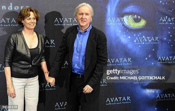 Actress Sigourney Weaver poses next to Canadian film director James Cameron during a photocall for their latest movie "Avatar" on December 8, 2009 in...