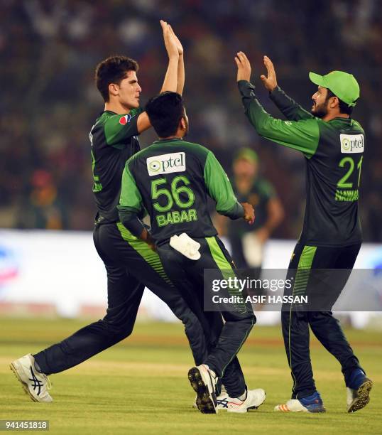 Pakistani cricketers Shaheen Afridi , Mohammad Nawaz and Babar Azam celebrate after the dismissal of West Indies captain Jason Mohammed during the...