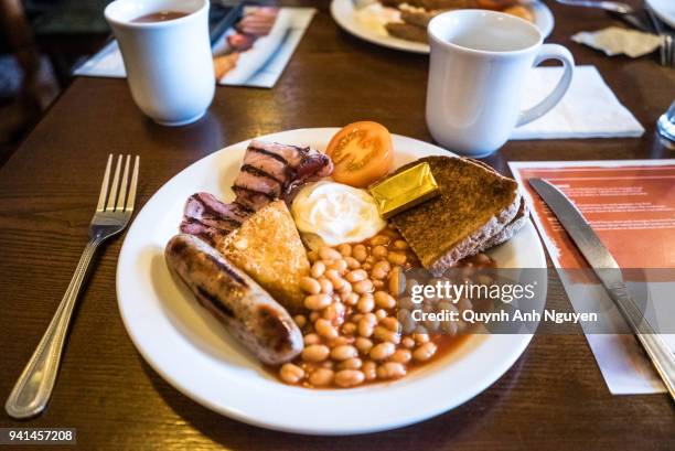 british food: close-up of english breakfast served in plate on table - english breakfast stock pictures, royalty-free photos & images