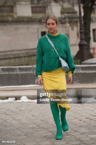 Fashion stylist Emili Sindlev wears a Loewe bag, Mulberry boots, Paco Rabanne knit dress and a Designers Remix sweater day 4 of Paris Womens Fashion...