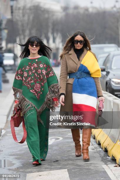 Fashion blogger Laura Comolli wears a ChiGlo poncho and trousers, Le Specs sunglasses and a Dior bag with Fashion blogger Elisa Taviti wearing Ralph...