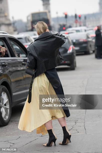 Editor in chief MINT Magazine Irina Lakicevic wears a Celine skirt and boots, Balenciaga jacket day 4 of Paris Womens Fashion Week Spring/Summer...