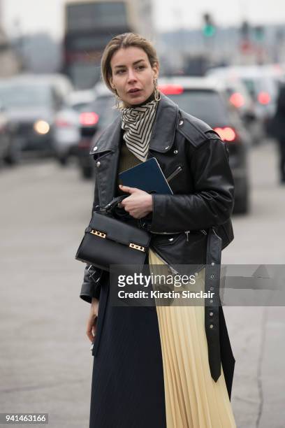 Editor in chief of MINT Magazine Irina Lakicevic wears a Celine skirt, Balenciaga jacket, Totome scarf and a Delvaux bag day 4 of Paris Womens...