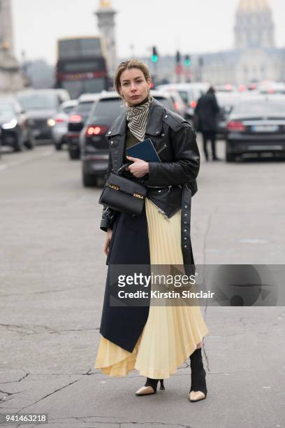 Editor in chief of MINT Magazine Irina Lakicevic wears a Celine skirt and boots, Balenciaga jacket, Totome scarf and a Delvaux bag day 4 of Paris...