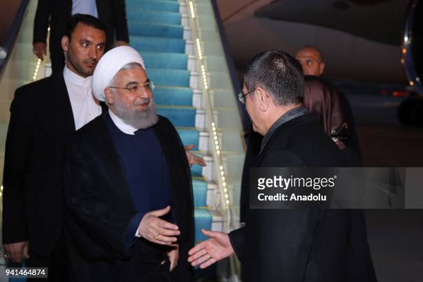 Iranian President Hassan Rouhani is welcomed by Turkish National Defense Minister Nurettin Canikli at Esenboga International Airport in Ankara,...