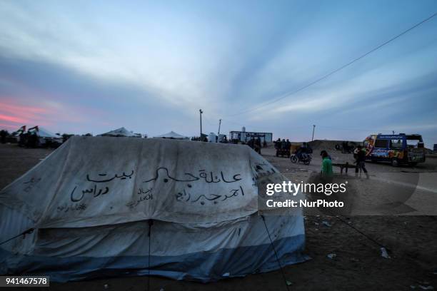 Palestinians are burning firewood to heat out their tents at sunset. On April 2, 2018 along the border with Israel east of Gaza City during a tent...