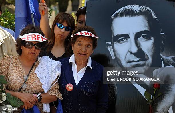 Supporters of Chilean former President and presidential candidate for the ruling coalition Eduardo Frei accompany their candidate during a visit at...