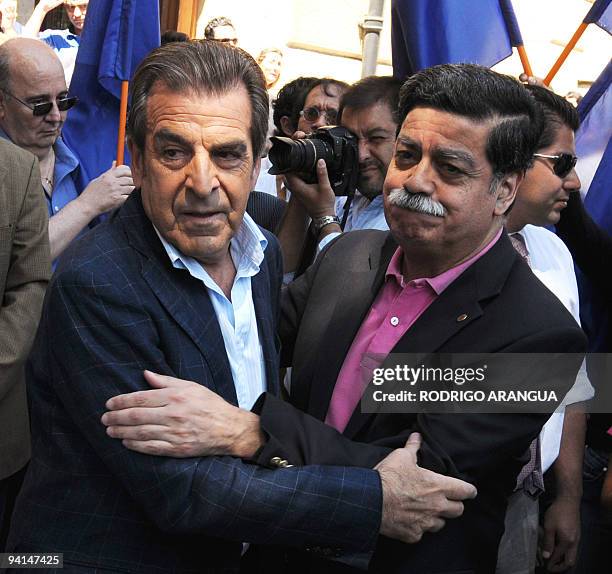 Chilean former President and presidential candidate for the ruling coalition, Eduardo Frei is greeted by a supporter during a visit at the cemetery...