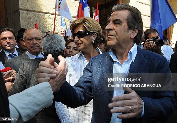 Chilean former President and presidential candidate for the ruling coalition, Eduardo Frei is greeted by a supporter during a visit at the cemetery...