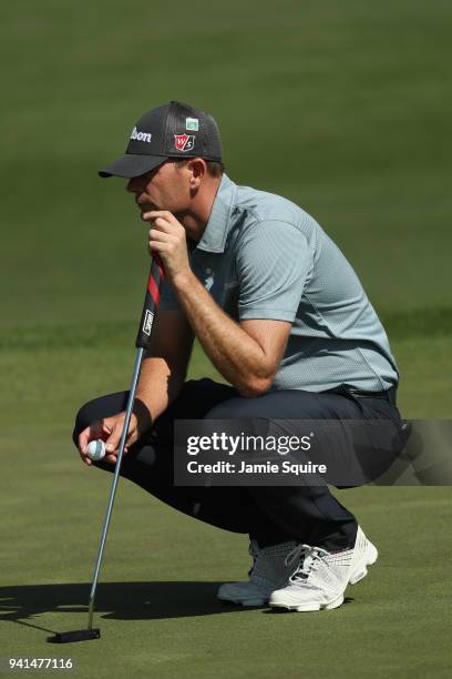 Brendan Steele of the United States lines up a putt during a practice round prior to the start of the 2018 Masters Tournament at Augusta National...