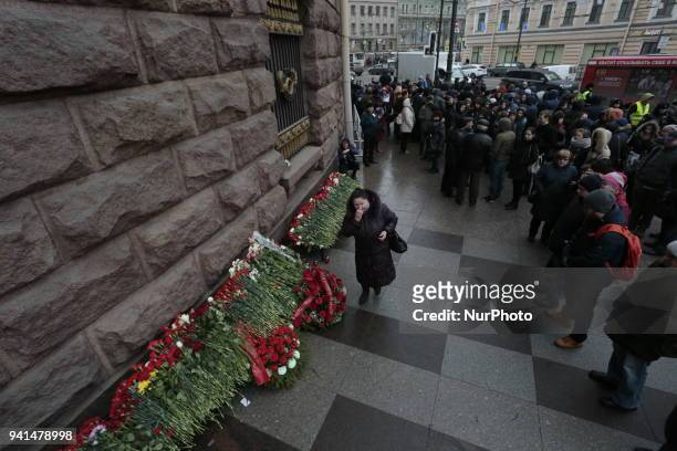 People put flowers during the rally in memory of the victims of the explosion in the St. Petersburg metro on the first anniversary of the attack. St....