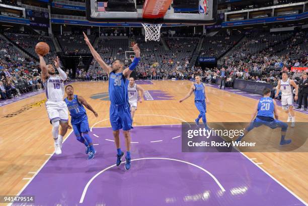 Frank Mason III of the Sacramento Kings shoots against Salah Mejri of the Dallas Mavericks on March 27, 2018 at Golden 1 Center in Sacramento,...
