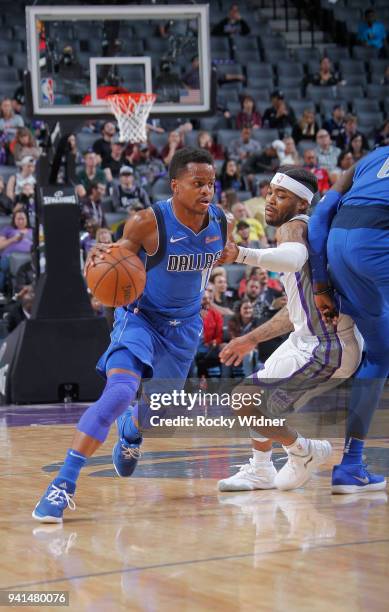 Yogi Ferrell of the Dallas Mavericks drives against Frank Mason III of the Sacramento Kings on March 27, 2018 at Golden 1 Center in Sacramento,...