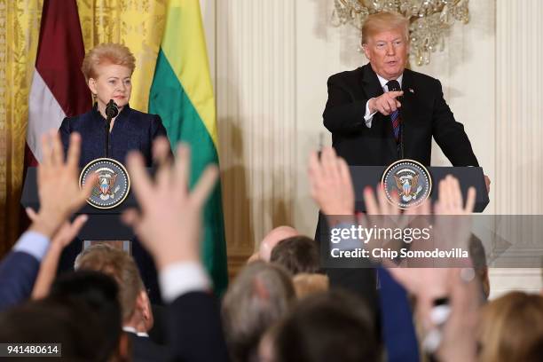 Lithuanian President Dalia Grybauskaite joins U.S. President Donald Trump as he calls on a reporter during a joint news conference in the East Room...