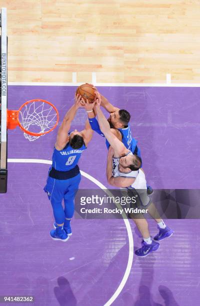 Kyle Collinsworth and Salah Mejri of the Dallas Mavericks rebound against Kosta Koufos of the Sacramento Kings on March 27, 2018 at Golden 1 Center...
