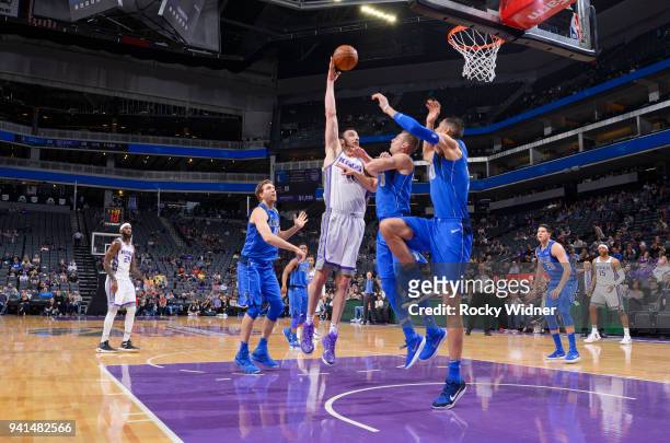 Kosta Koufos of the Sacramento Kings shoots against Kyle Collinsworth of the Dallas Mavericks on March 27, 2018 at Golden 1 Center in Sacramento,...