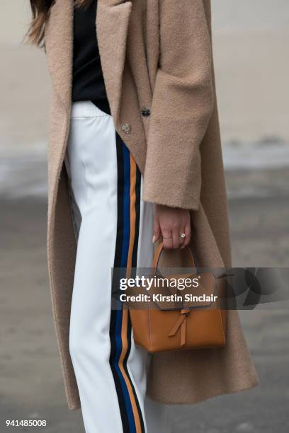 Fashion blogger Felicia Evalina wears Zara trousers, Day Birger et Mikkelsen coat and an Alexandra de Curtis bag day 4 of Paris Womens Fashion Week...