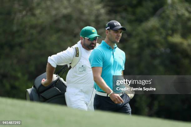 Martin Kaymer of Germany walks with his caddie Craig Connelly during a practice round prior to the start of the 2018 Masters Tournament at Augusta...