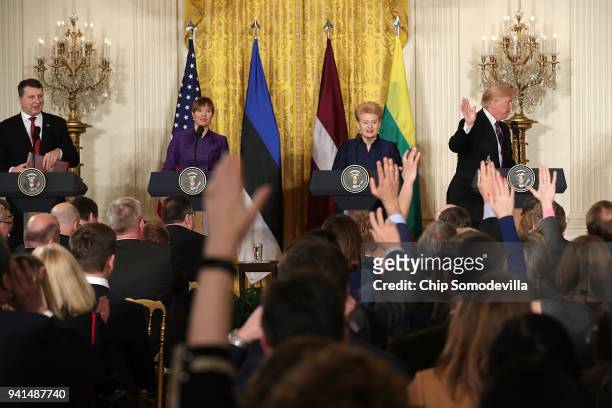 President Donald Trump waves as he walks off stage following a news conference with Latvian President Raimonds Vejonis, Estonian President Kersti...