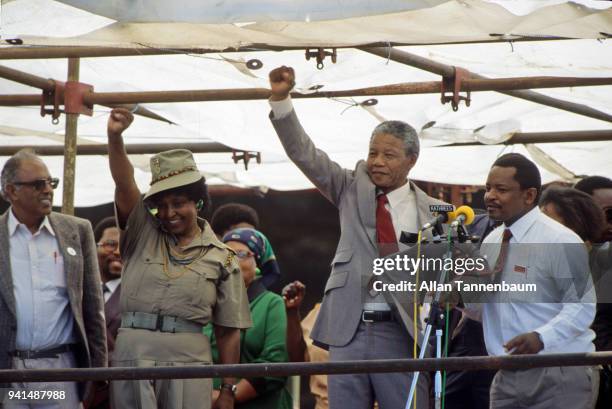 Married South African anti-apartheid activists Winnie Mandela and Nelson Mandela raise their first as the latter addressed supporters at an African...