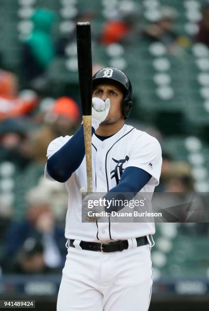 Mikie Mahtook of the Detroit Tigers warms his hand while batting against the Kansas City Royals during the second inning at Comerica Park on April 3,...