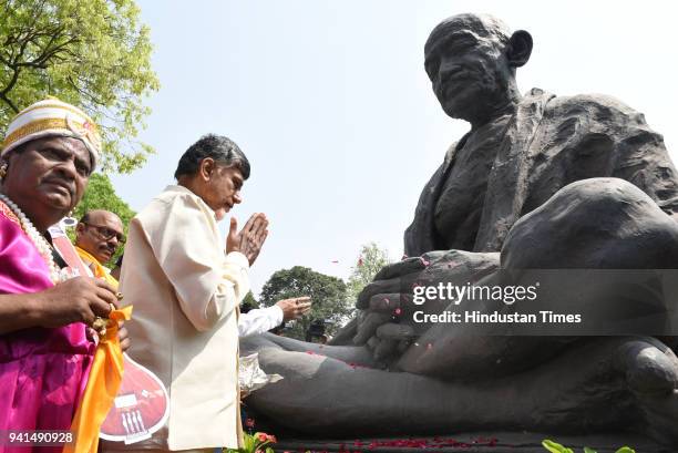 Andhra Pradesh Chief Minister N Chandrababu Naidu paying floral tributes on the statue of Mahatma Gandhi as he arrives to attend his party's protest...