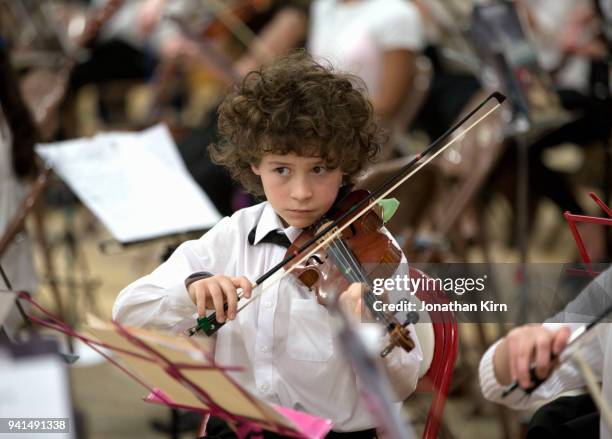 young violinist plays his instrument. - sad musician stock pictures, royalty-free photos & images