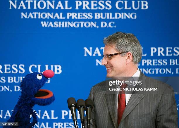 Sesame Workshop President and CEO Gary Knell speaks with Sesame Street character Grover at the National Press Club Newsmaker Luncheon Program on...