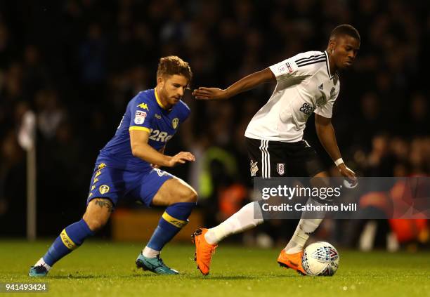 Floyd Ayite of Fulham is challenged by Gaetano Berardi of Leeds United during the Sky Bet Championship match between Fulham and Leeds United at...