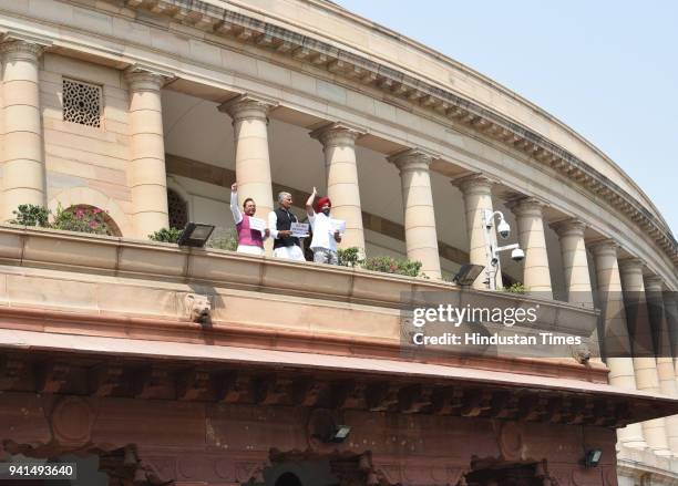 Congress MPs from Punjab raise slogans and display placards from the porch of Parliament House demanding compensation for the victims of Mosul during...