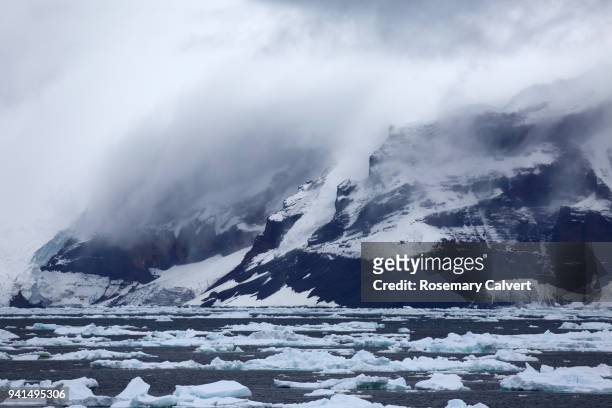mist hangs over mountains, antarctic sound, antarctica. - antarctic peninsula stock pictures, royalty-free photos & images