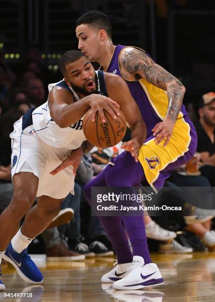 Kyle Kuzma of the Los Angeles Lakers and Aaron Harrison of the Dallas Mavericks battle for the ball in the game at Staples Center on March 28, 2018...
