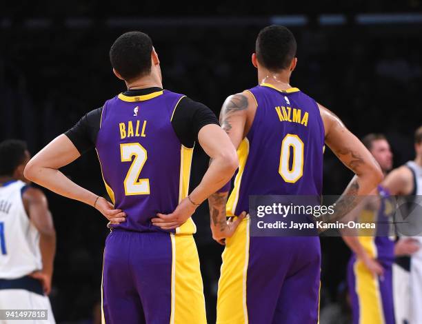 Kyle Kuzma and Lonzo Ball of the Los Angeles Lakers wait on the court during a time out in the game against the Dallas Mavericks at Staples Center on...