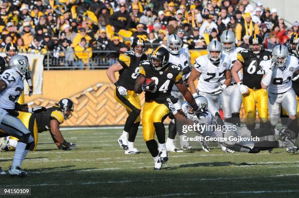 Running back Rashard Mendenhall of the Pittsburgh Steelers runs against safety Michael Huff of the Oakland Raiders at Heinz Field on December 6, 2009...