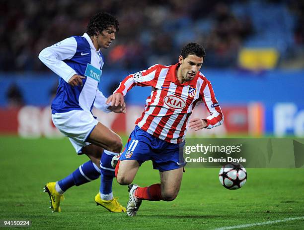 Maxi Rodriguez of Atletico Madrid is tackled by Bruno Alves of FC Porto during the UEFA Champions League Group D match between Atletico Madrid and FC...