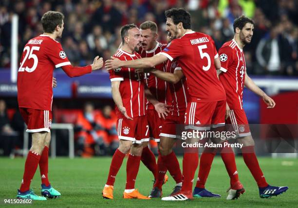 Franck Ribery of Bayern Muenchen celebrates with his team mates after scoring his sides first goal after his shot was deflected in by Jesus Navas of...