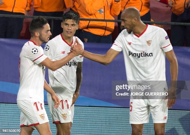 Sevilla's Spanish midfielder Pablo Sarabia celebrates a goal with Sevilla's Argentinian midfielder Joaquin Correa and Sevilla's French midfielder...