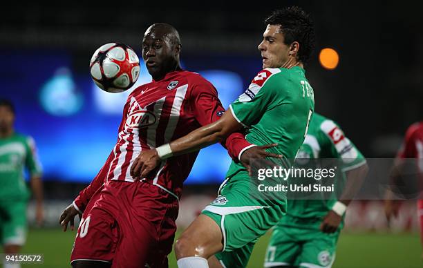 Henri Saivet of Bordeaux shields the ball from Jorge Teixeira of Maccabi Haifa during their UEFA Champions League Group A match between Maccabi Haifa...