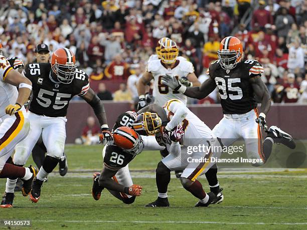 Wide receiver Santana Moss of the Washington Redskins is stopped by defensive back Sean Jones of the Cleveland Browns during a game on October 19,...