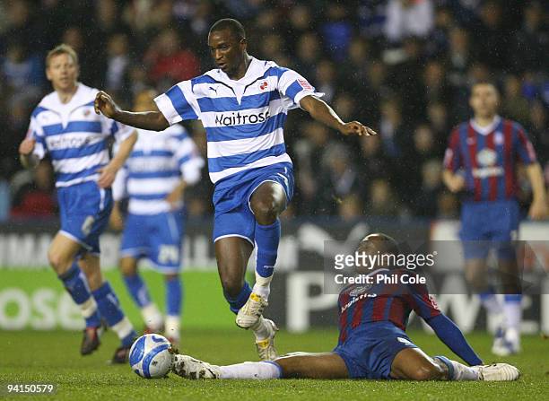 Kalifa Cisse of Reading avoids a tackle by Neil Danns of Crystal Palace during the Coca Cola Championship match between Reading and Crystal Palace at...