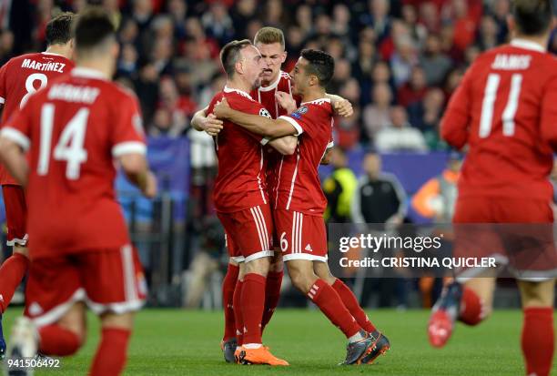 Bayern players celebrate Sevilla's Spanish midfielder Jesus Navas' own goal during the UEFA Champions League quarter-final first leg football match...