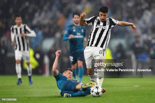 Sami Khedira of Juventus competes for the ball with Toni Kroos of Real Madrid during the UEFA Champions League Quarter Final Leg One match between...